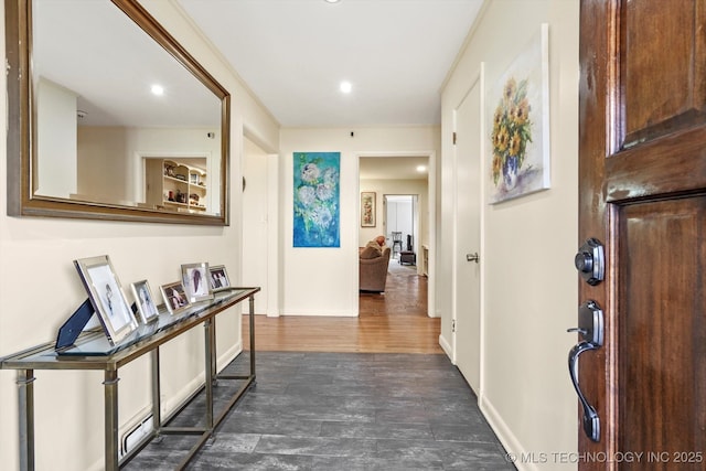 hall with dark wood-type flooring and baseboards