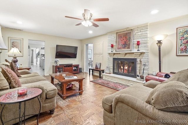 living room featuring visible vents, a ceiling fan, recessed lighting, a fireplace, and baseboards