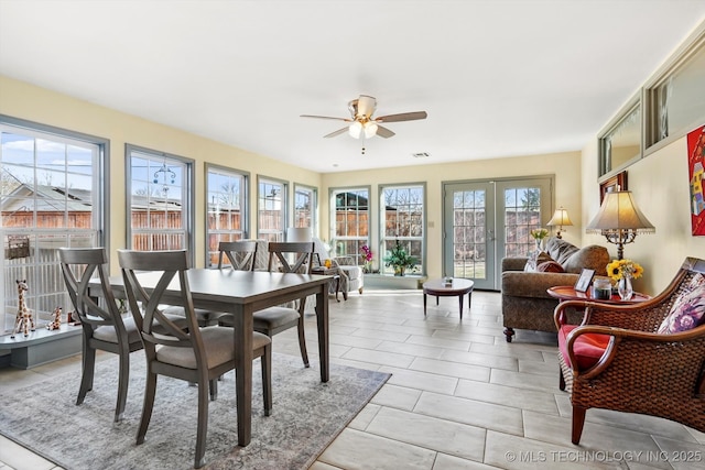 sunroom featuring a ceiling fan and visible vents