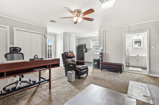 office area featuring a wealth of natural light, visible vents, and ceiling fan