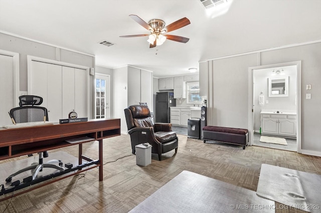 office space with visible vents, plenty of natural light, and ceiling fan