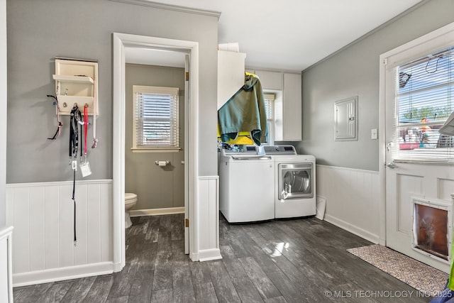 clothes washing area featuring a wainscoted wall, laundry area, electric panel, dark wood-style flooring, and washer and dryer