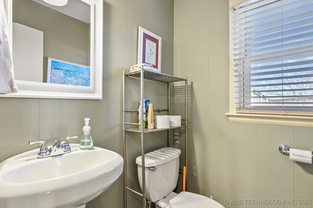 bathroom with toilet and a sink