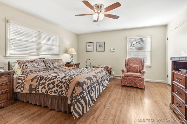 bedroom with light wood-style flooring, baseboards, and ceiling fan