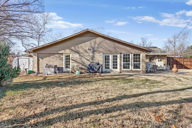 back of property featuring a lawn, a patio, and fence