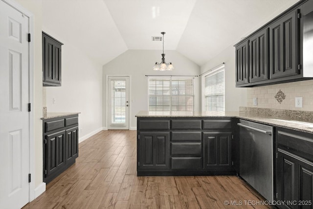 kitchen with light wood-type flooring, dark cabinetry, a peninsula, an inviting chandelier, and dishwasher