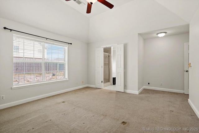 unfurnished bedroom with lofted ceiling, carpet, baseboards, and visible vents