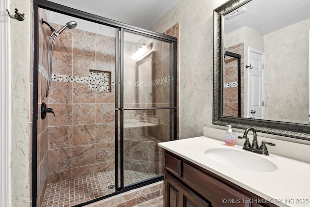 full bath featuring a shower stall and vanity