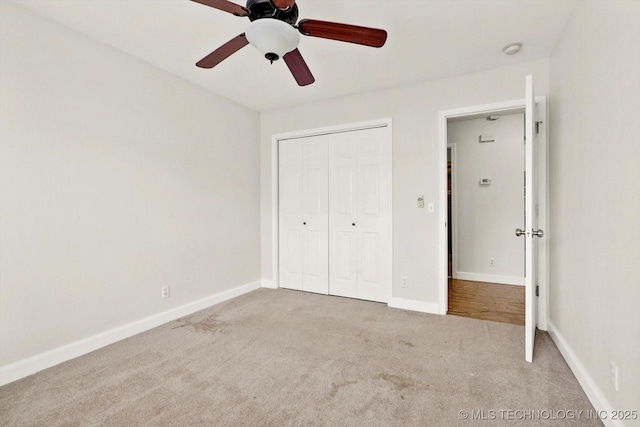 unfurnished bedroom with a closet, ceiling fan, baseboards, and carpet