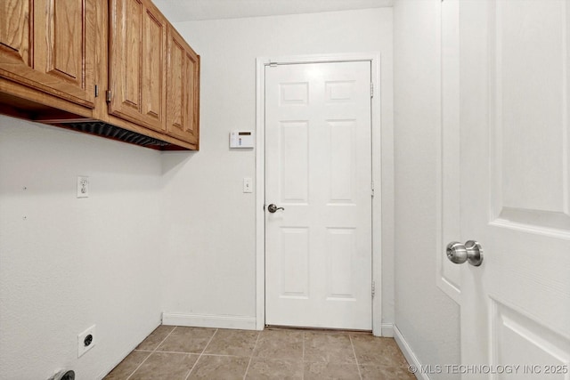 washroom featuring light tile patterned floors, cabinet space, baseboards, and electric dryer hookup