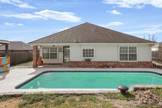 view of swimming pool with a patio area, a fenced in pool, and fence