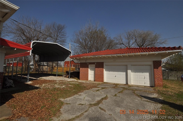 detached garage featuring a carport