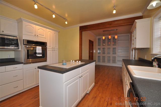 kitchen with white cabinetry, dark countertops, and appliances with stainless steel finishes