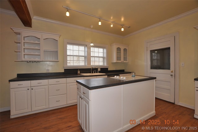 kitchen featuring a sink, dark countertops, dark wood-style floors, and white cabinets