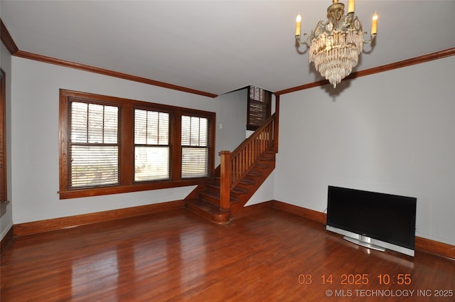 unfurnished living room with stairway, wood finished floors, an inviting chandelier, and ornamental molding