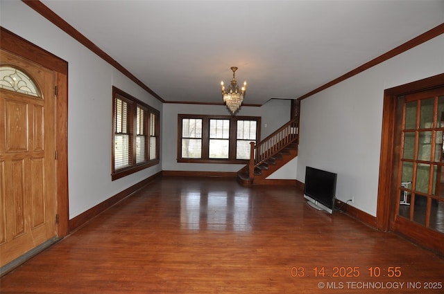 unfurnished living room with crown molding, baseboards, a chandelier, stairs, and wood finished floors