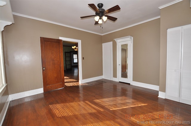 unfurnished bedroom with ceiling fan with notable chandelier, wood finished floors, baseboards, and ornamental molding