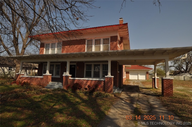 view of front of property with brick siding, covered porch, driveway, and an outdoor structure