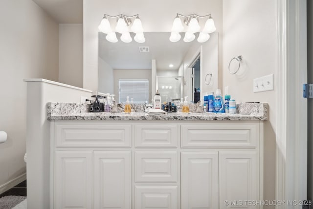 bathroom with double vanity, toilet, visible vents, and a stall shower