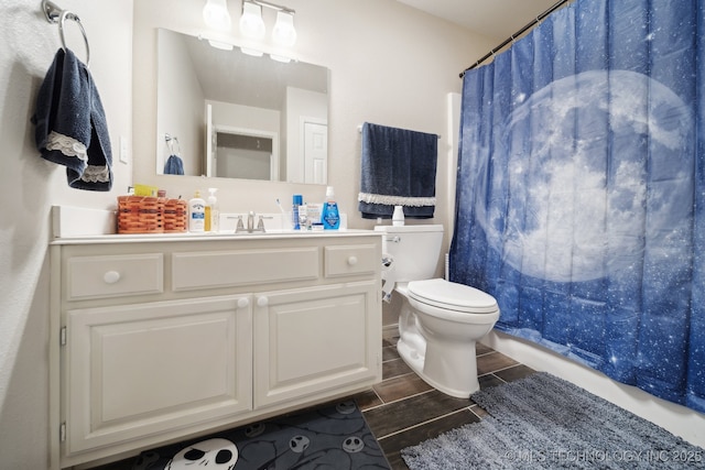 full bath with wood finish floors, a shower with curtain, toilet, and vanity