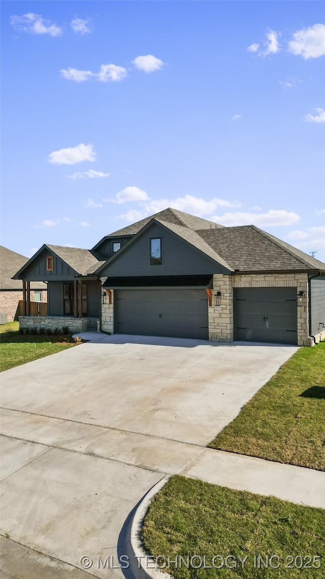 ranch-style house featuring driveway, stone siding, roof with shingles, a front yard, and a garage