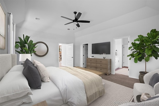 carpeted bedroom with visible vents, connected bathroom, and ceiling fan