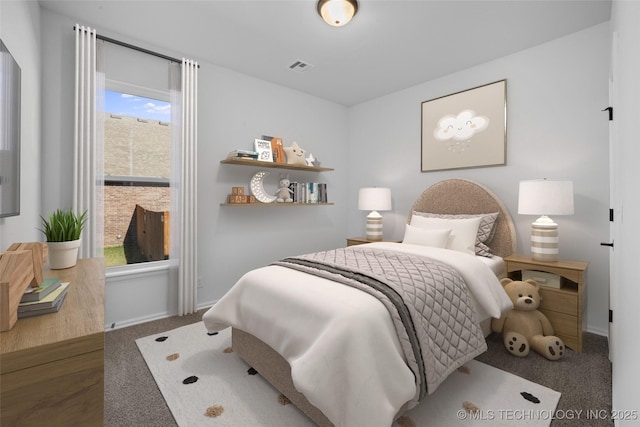 bedroom featuring visible vents and baseboards