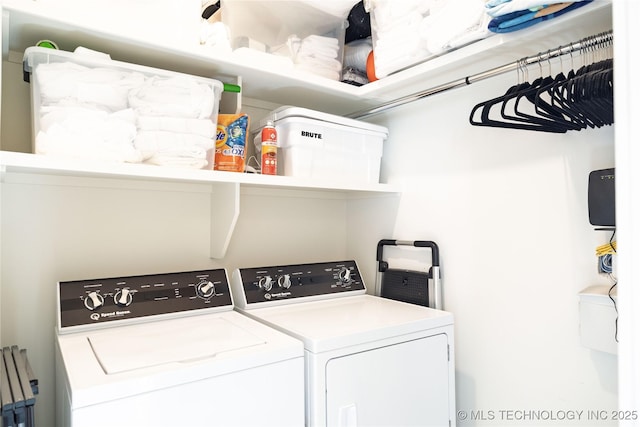 clothes washing area featuring laundry area and separate washer and dryer