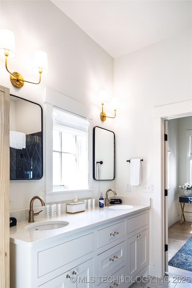 full bath featuring double vanity and a sink