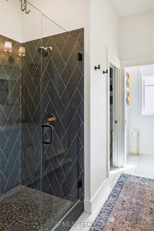 full bathroom with tile patterned flooring, a shower stall, and baseboards