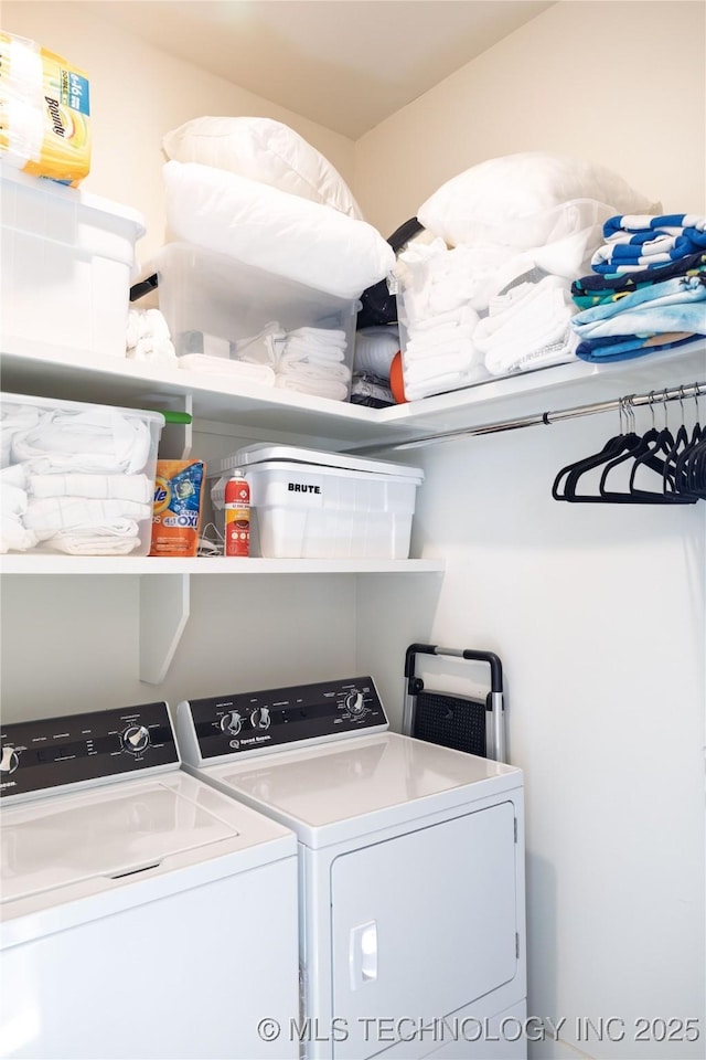 washroom featuring laundry area and washing machine and clothes dryer