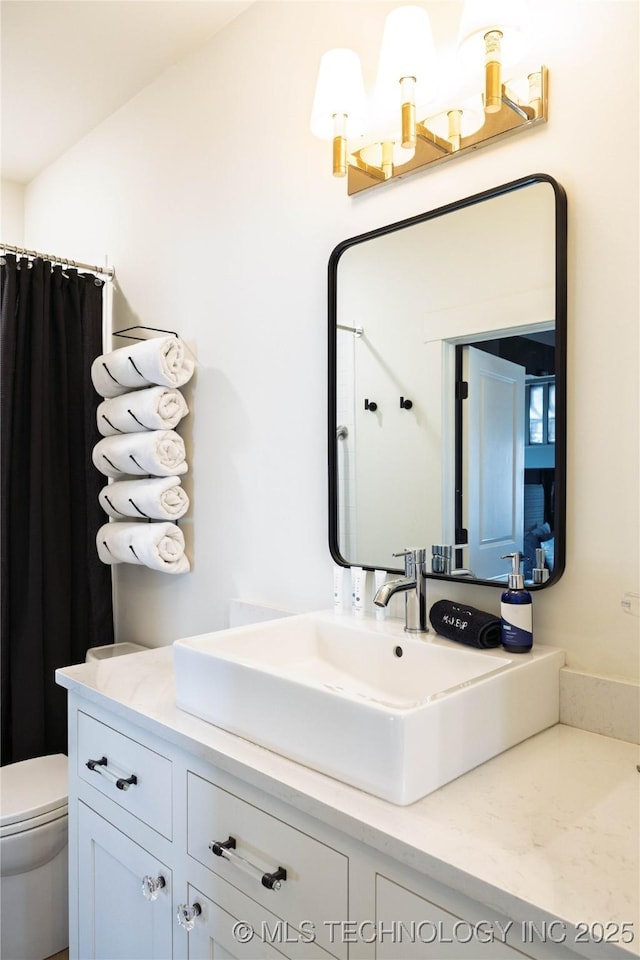 bathroom with toilet and vanity