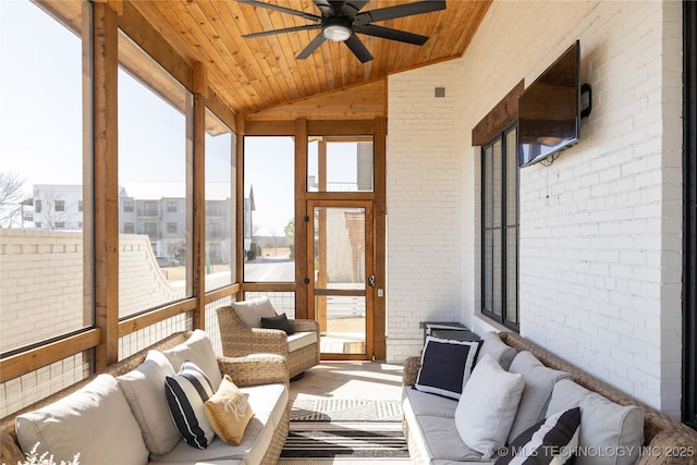 sunroom / solarium featuring wood ceiling, a ceiling fan, and vaulted ceiling