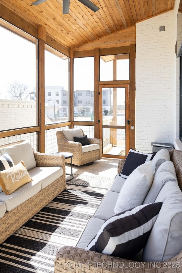 living area featuring ceiling fan, wooden ceiling, brick wall, and vaulted ceiling