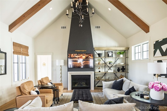 living area with visible vents, high vaulted ceiling, and beamed ceiling