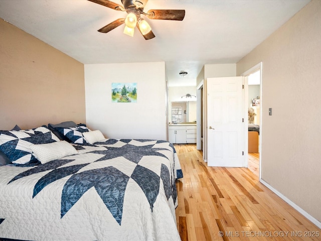 bedroom with ensuite bath, baseboards, light wood-type flooring, and ceiling fan