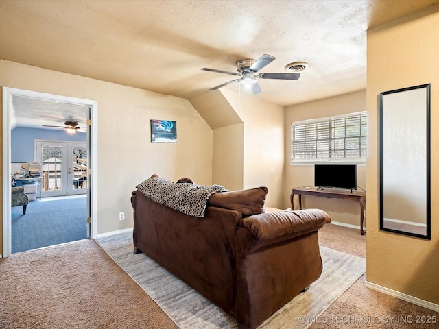 living room featuring visible vents, light carpet, plenty of natural light, and a ceiling fan