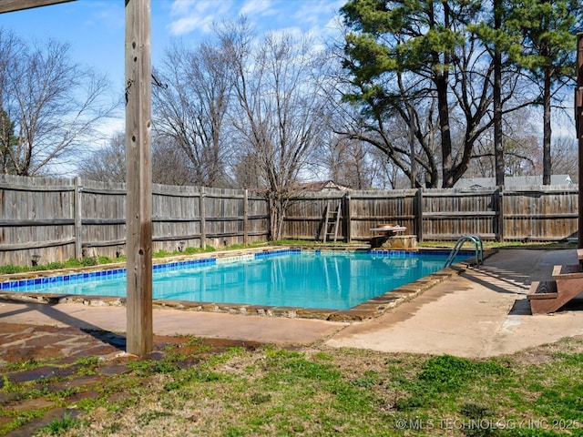 view of swimming pool featuring a diving board, a fenced in pool, a fenced backyard, and a patio area