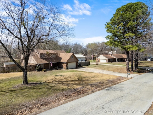 view of front of property featuring an attached garage, concrete driveway, a front lawn, and board and batten siding