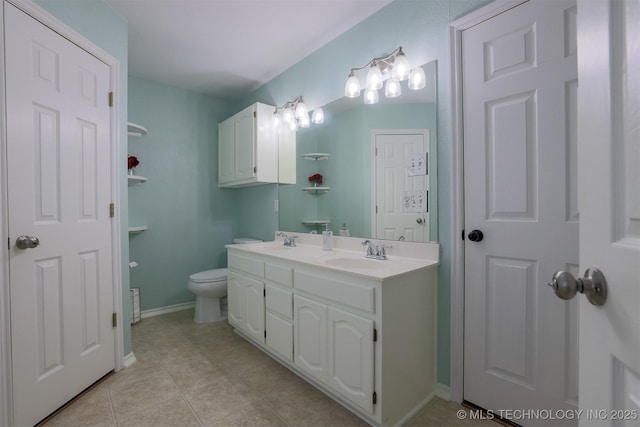 bathroom featuring tile patterned flooring, double vanity, toilet, and a sink