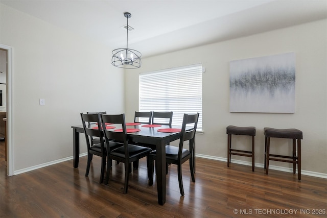 dining room featuring visible vents, baseboards, an inviting chandelier, and wood finished floors