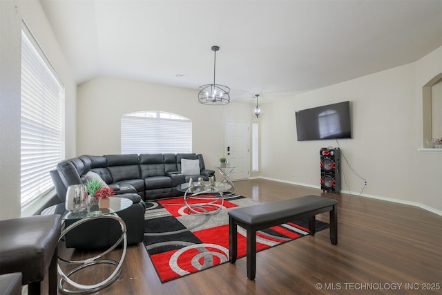 living area featuring plenty of natural light, baseboards, and wood finished floors