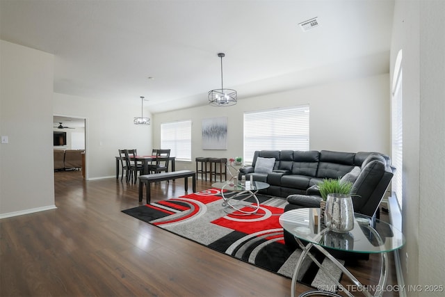 living room featuring wood finished floors, visible vents, and baseboards