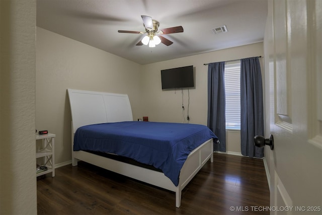 bedroom featuring visible vents, baseboards, wood finished floors, and a ceiling fan