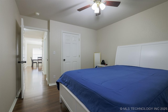 bedroom featuring baseboards, dark wood-type flooring, and ceiling fan