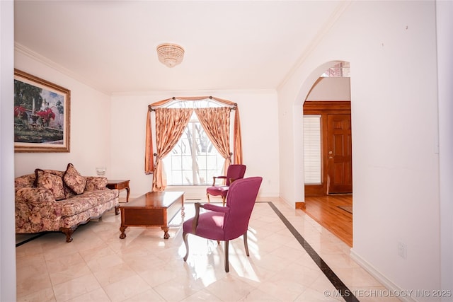 living area with baseboards, arched walkways, and crown molding