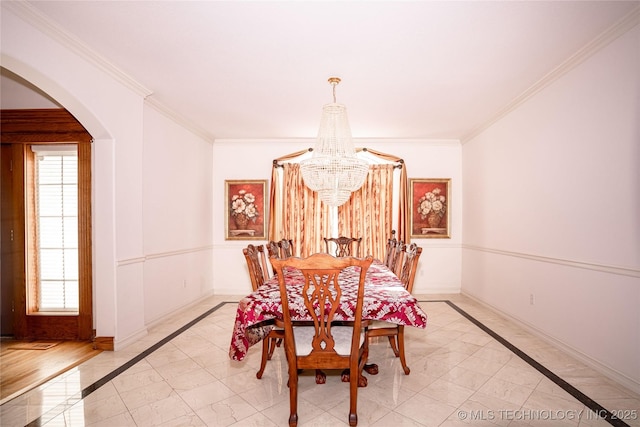 dining room with a notable chandelier, arched walkways, baseboards, and a wealth of natural light