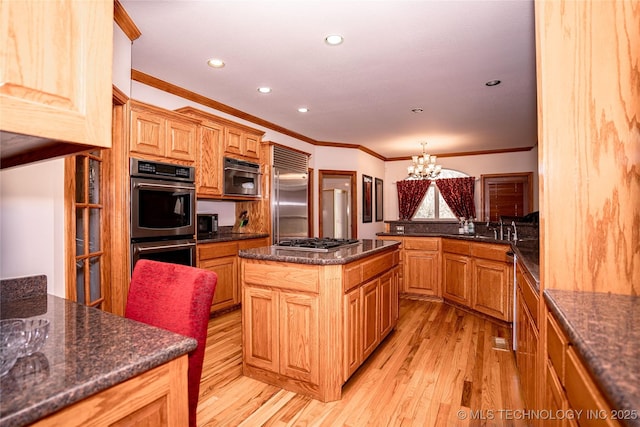 kitchen featuring recessed lighting, appliances with stainless steel finishes, crown molding, light wood finished floors, and a chandelier