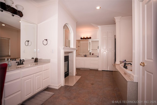 full bath featuring a sink, two vanities, recessed lighting, and ornamental molding