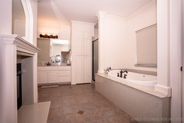 bathroom with a bath, a stall shower, vanity, and ornamental molding